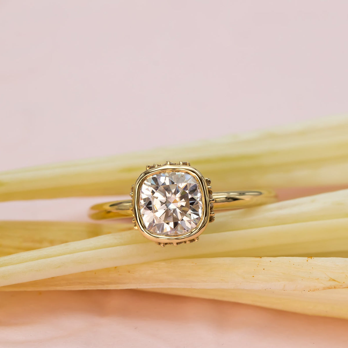 Elegant cushion-cut diamond ring in solid gold with sculpted bezel and side diamonds, handcrafted in a vintage-inspired modern design.

