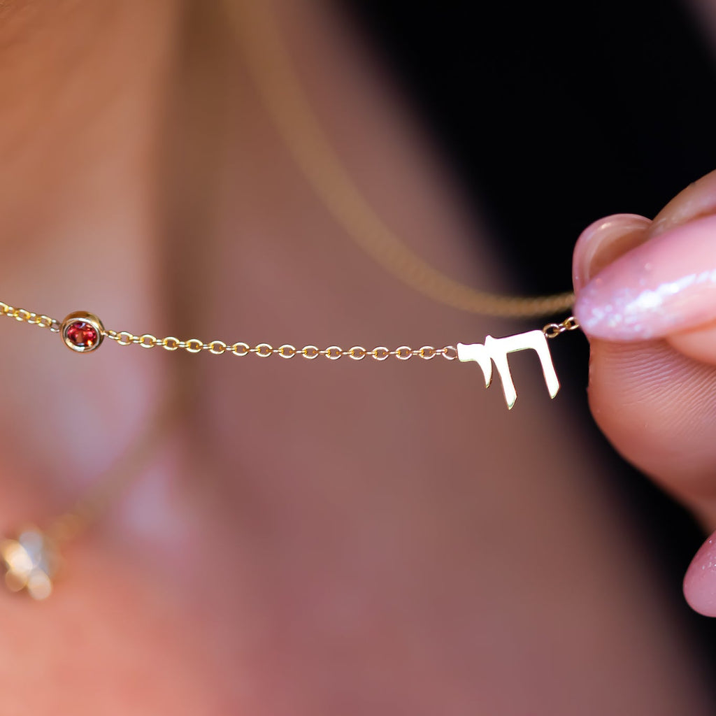 Chai necklace in solid gold with red garnet detail | Hebrew necklace by Sivan Lotan Jewelry
