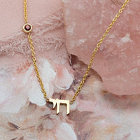 Chai necklace in solid gold with red garnet detail | Hebrew necklace by Sivan Lotan Jewelry