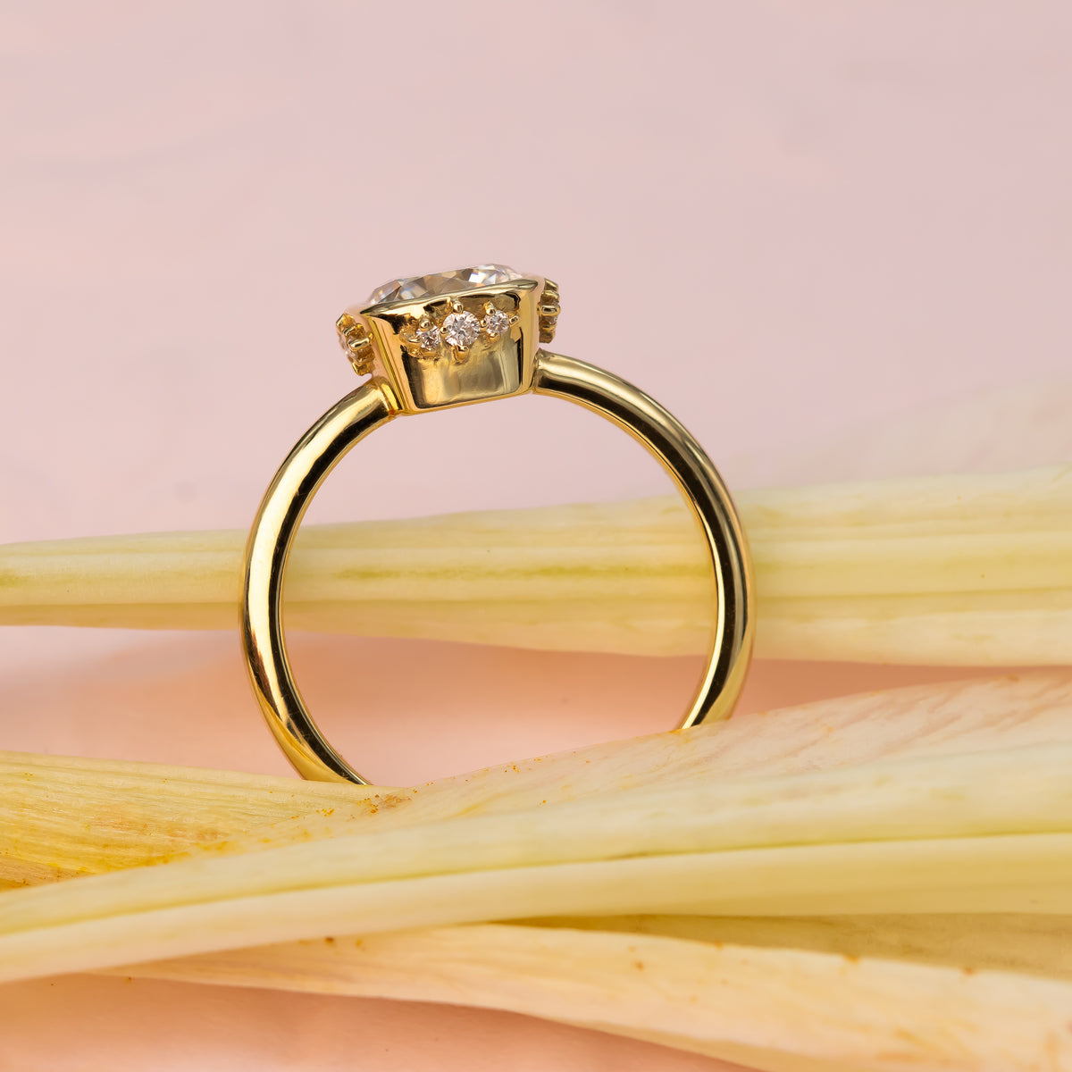 Elegant cushion-cut diamond ring in solid gold with sculpted bezel and side diamonds, handcrafted in a vintage-inspired modern design.