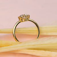 Elegant cushion-cut diamond ring in solid gold with sculpted bezel and side diamonds, handcrafted in a vintage-inspired modern design.