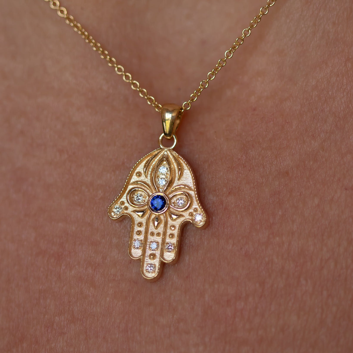 Floral Hamsa Necklace with Blue Sapphire & Diamonds | Symbolic Jewelry