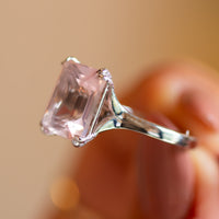 Alternative engagement ring with rose quartz, split-shoulder gold band with diamond accents