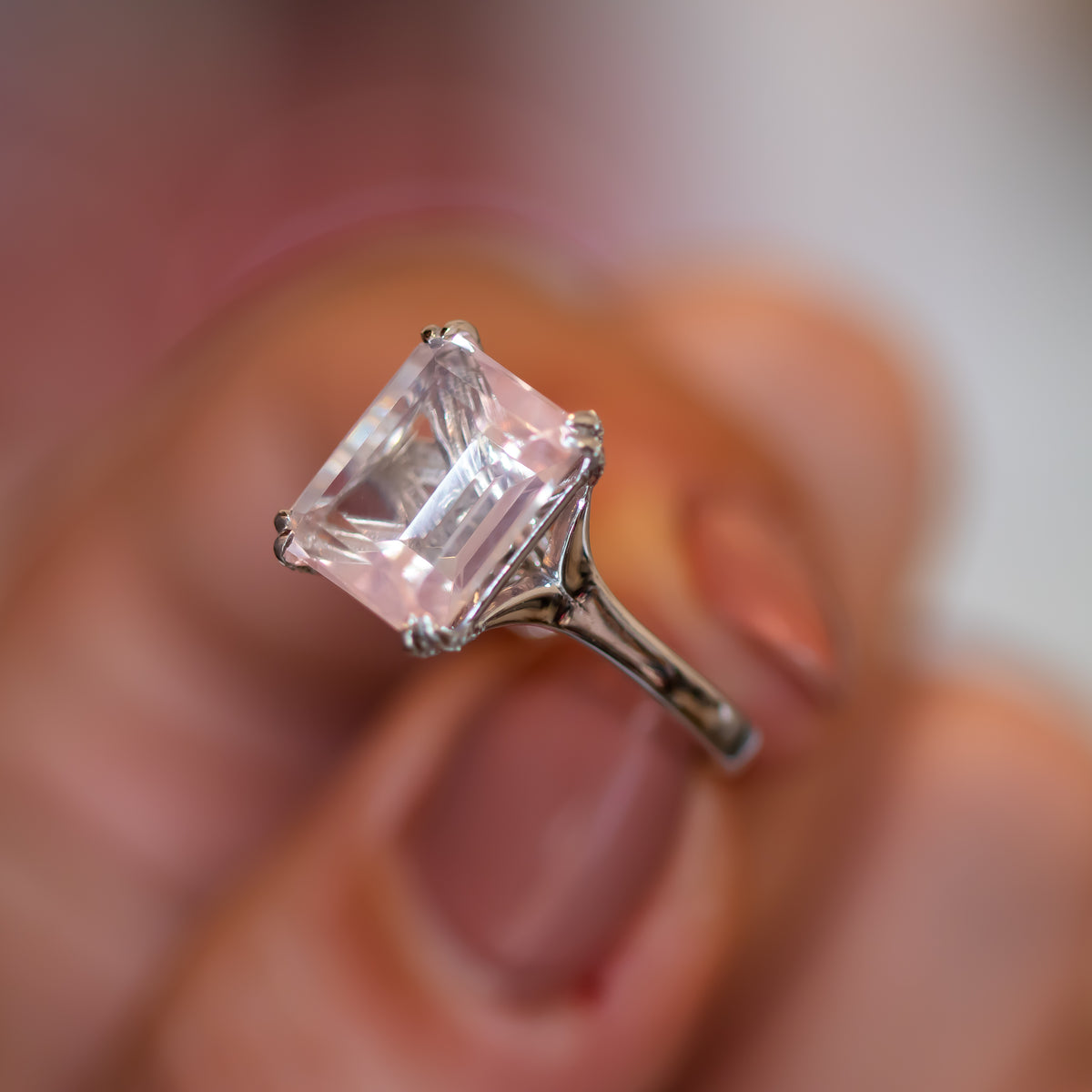 Rose quartz engagement ring with pavé diamond gallery, pale pink step-cut centre stone on a slender gold band