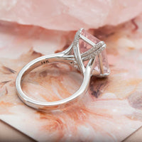 Rose quartz and diamond ring in white gold styled against a raw rose quartz crystal