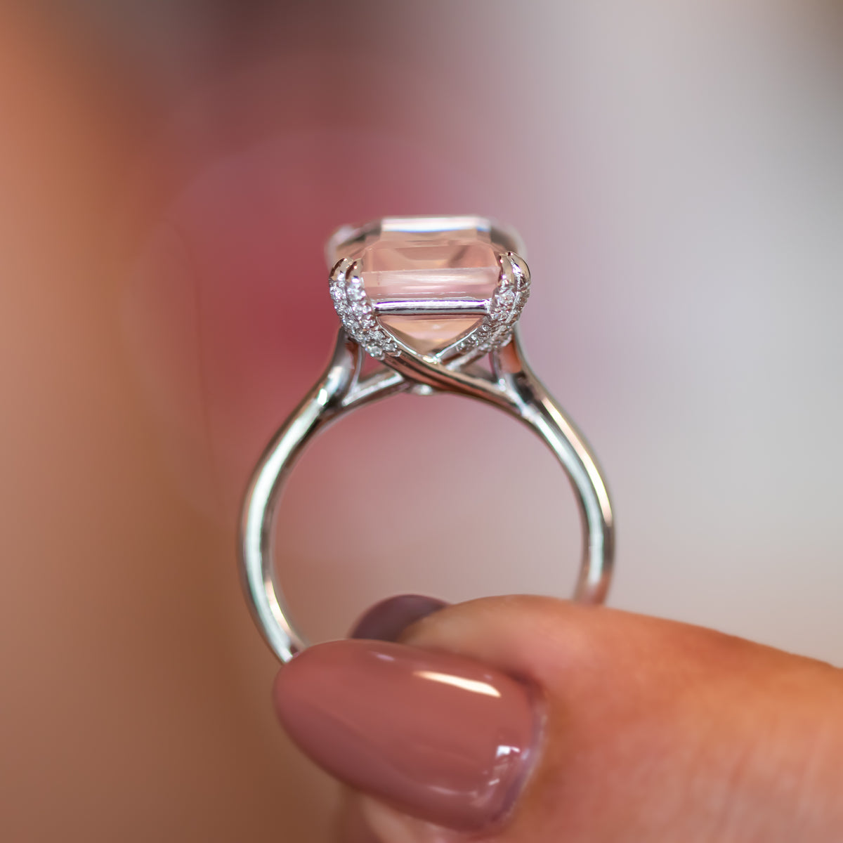 Side profile of the Verena rose quartz ring showing diamond-set shoulders and tapered gold band