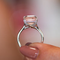 Side profile of the Verena rose quartz ring showing diamond-set shoulders and tapered gold band