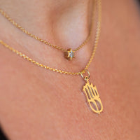 Shalom שלום Pendant charm necklace with Star of David Diamond charm pendant in 14k gold on body