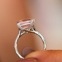 Side profile of the Verena rose quartz ring showing diamond-set shoulders and tapered gold band