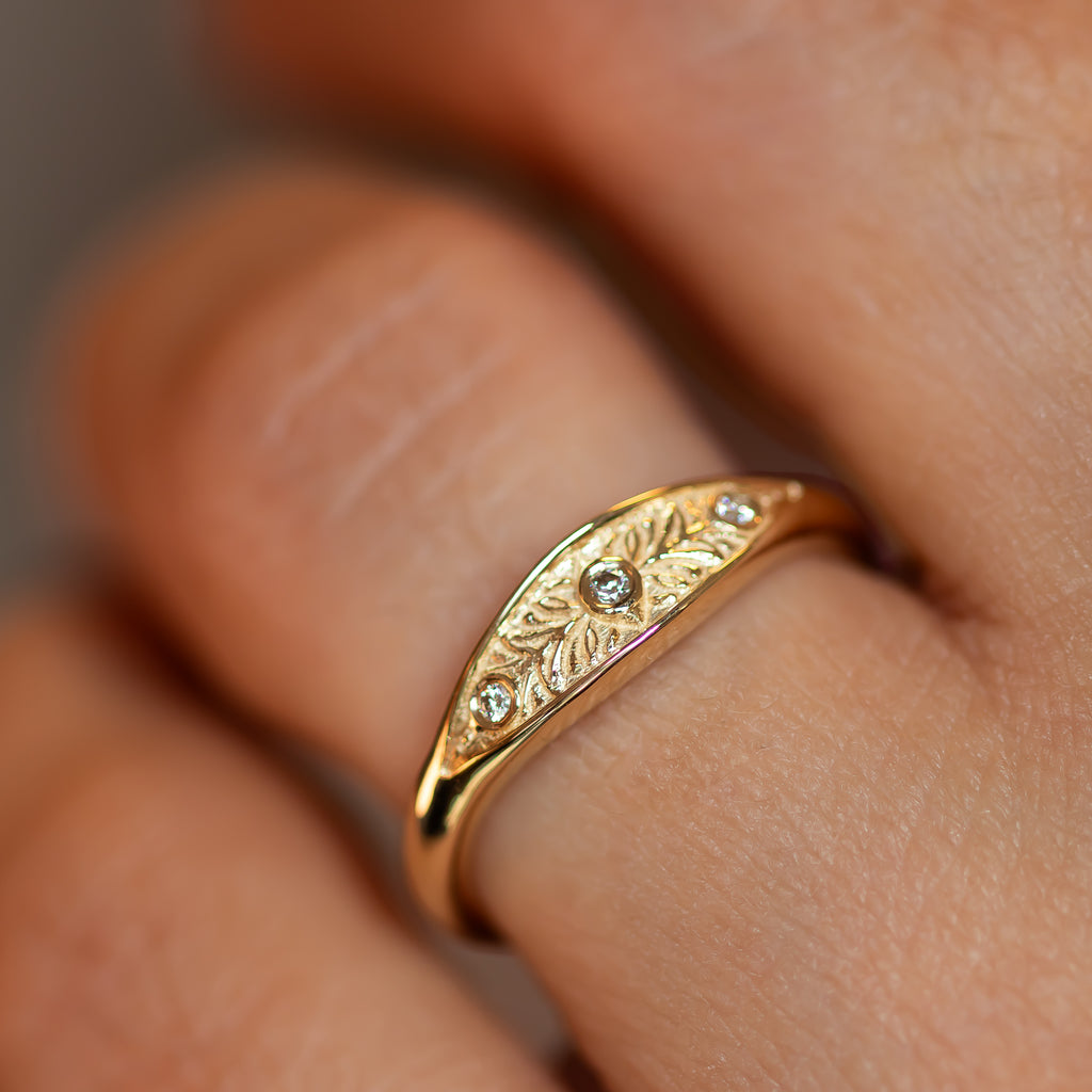 VERA – a gold floral engraved ring with three tiny diamonds, handmade in solid gold with delicate botanical detailing.