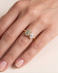 elara-green-damond and sapphire engagement-ring-on-hand close up