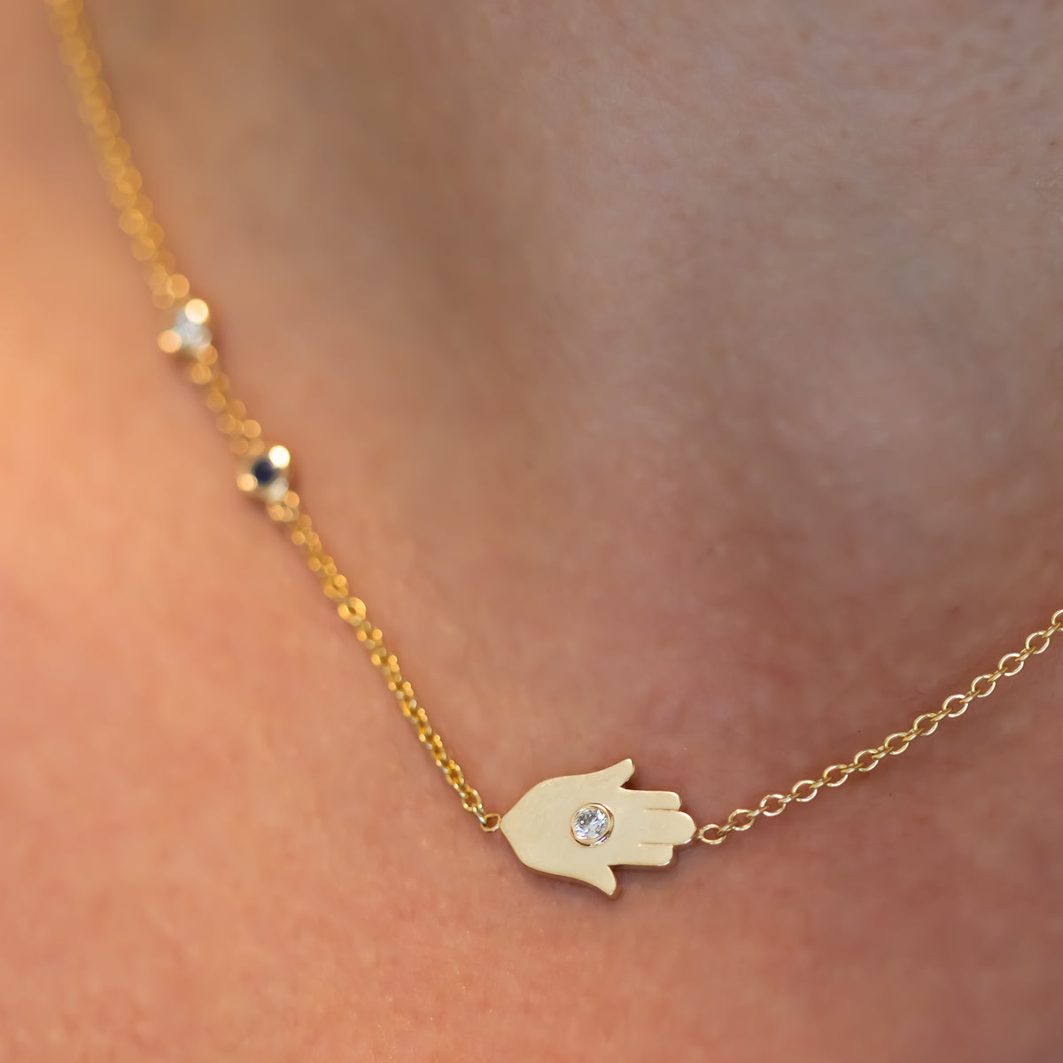 Sideways Hamsa Necklace with Diamonds and Sapphire