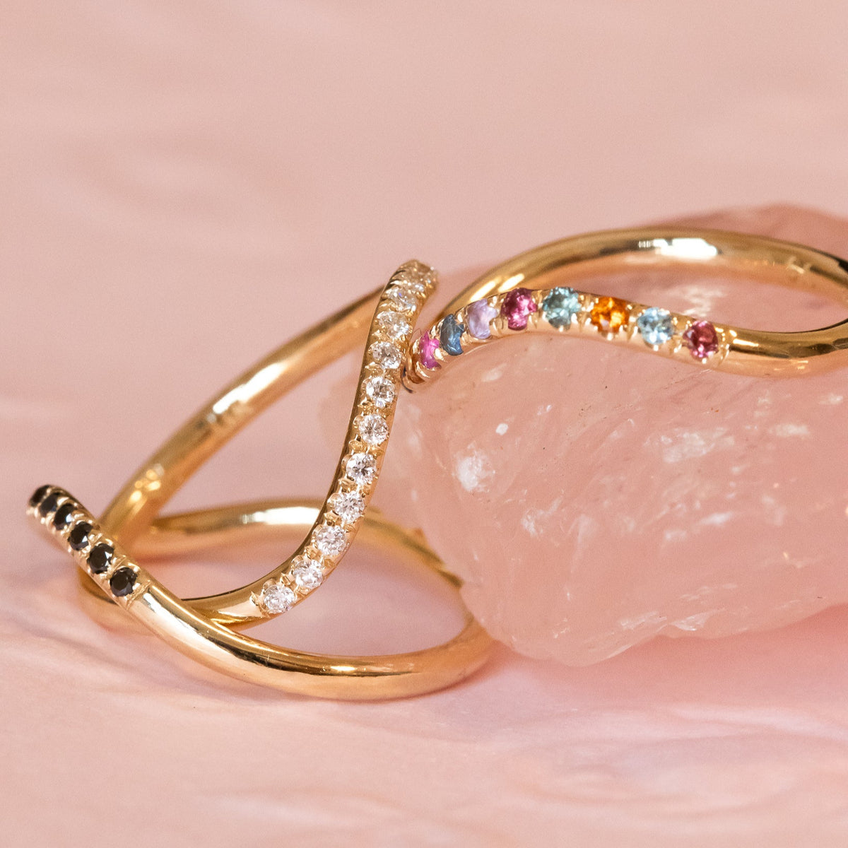 rainbow sapphire ring, black diamond ring, and white diamond ring